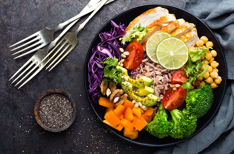 Colourful plate of food with three forks